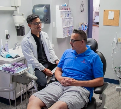 Lexington dentist Dr. Kevin Kem talking with his patient